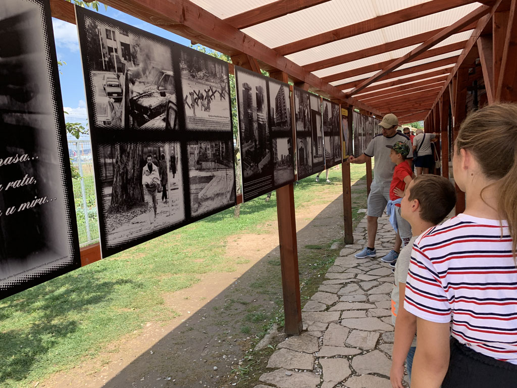 Buiten hangen foto's van Sarajevo in oorlogstijd en van de tunnel.