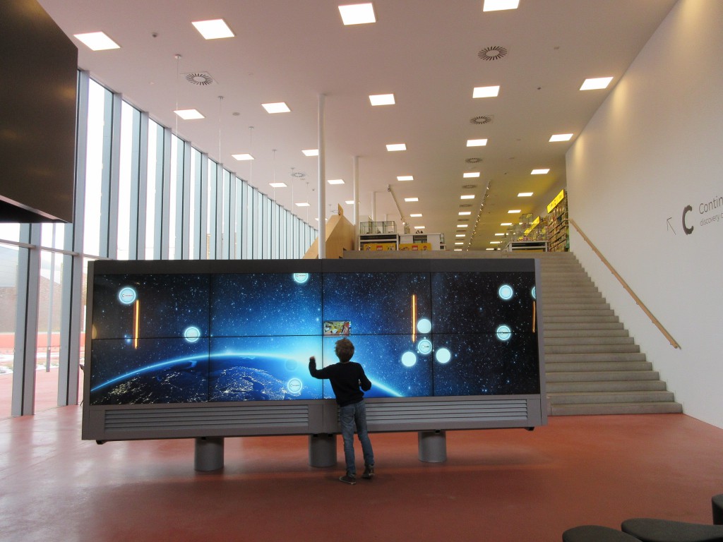 Het grote scherm in de centrale hal nodigt uit tot aanraken