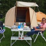 De inklapbare picknicktafel met losse stoelen voor de volwassenen.