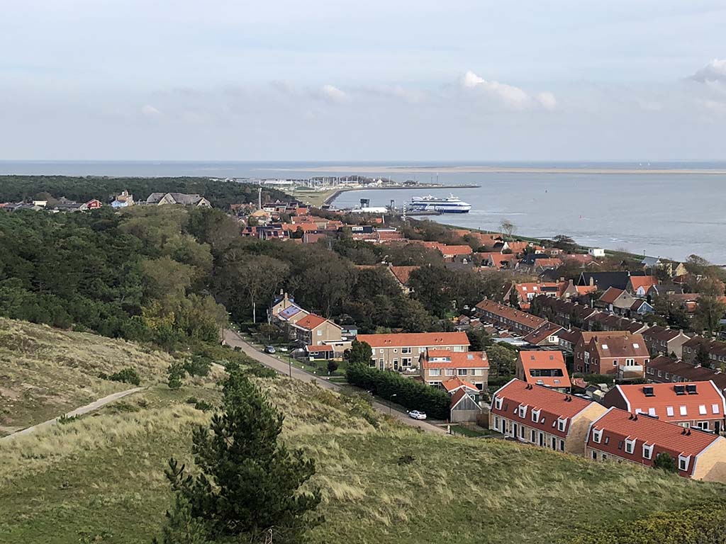 Uitzicht op het enige dorp van Vlieland en de aanlegplaats van de boot